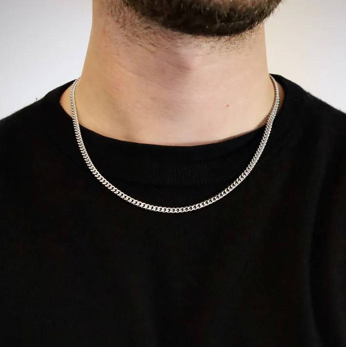 4mm silver stainless steel Cuban link chain worn by a man over a black t-shirt