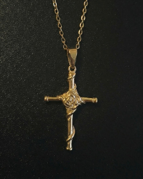 Gold rose cross pendant with a sculpted rose and vine down the lower arm, close detail
