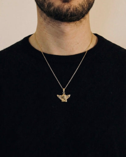 Man wearing a gold angel necklace on a 50cm chain over a black t-shirt