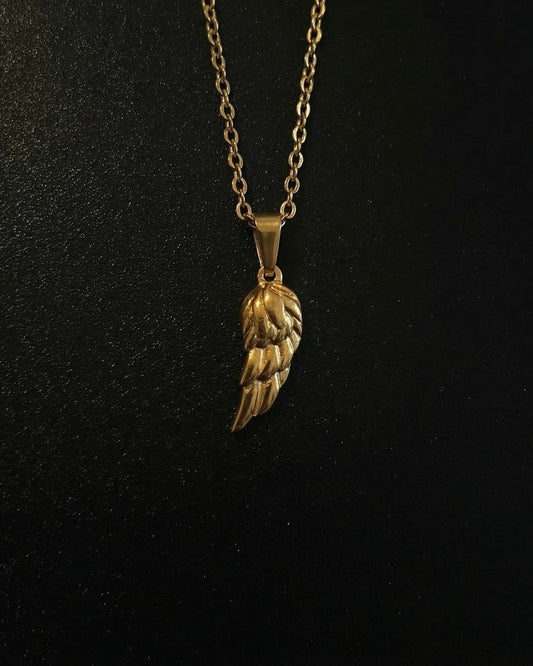 Gold angel wing pendant with layered feathers and a polished finish, close detail