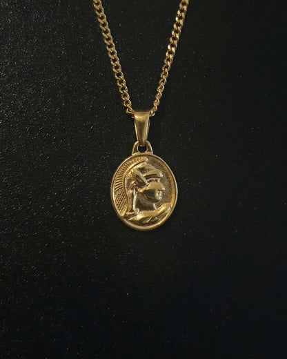 Gold centurion pendant with a Roman soldier in a crested helmet on an oval medallion, close detail