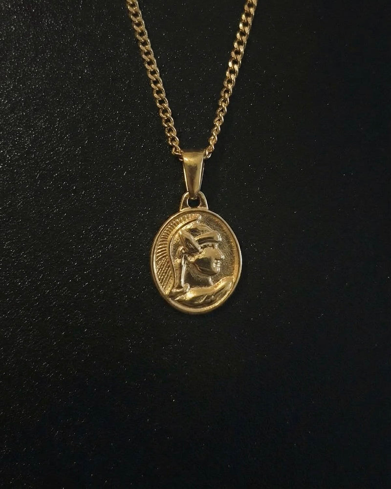 Gold centurion pendant with a Roman soldier in a crested helmet on an oval medallion, close detail