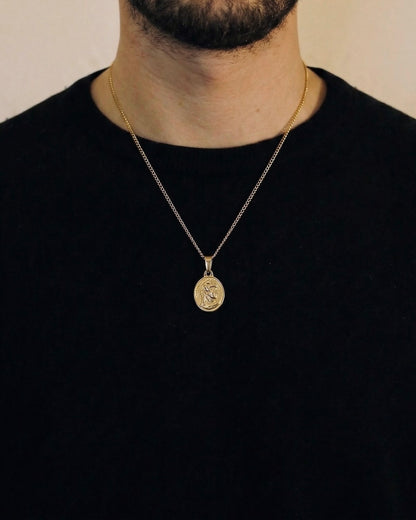 Man wearing a gold centurion necklace on a 50cm chain over a black t-shirt