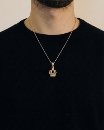 Man wearing a gold crown necklace on a 50cm chain over a black t-shirt