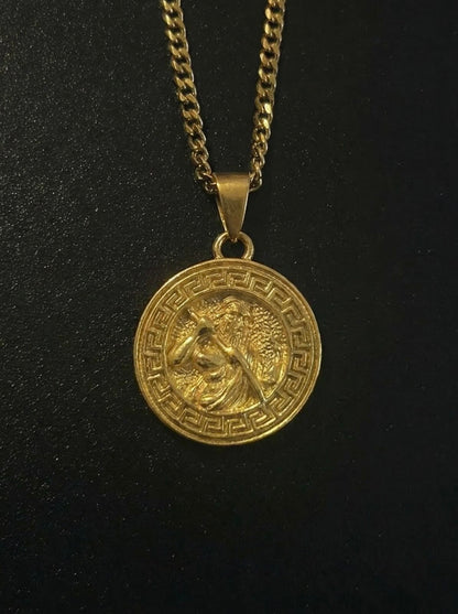 Gold Greek Zeus pendant with a bearded Zeus figure and Greek key border, close detail