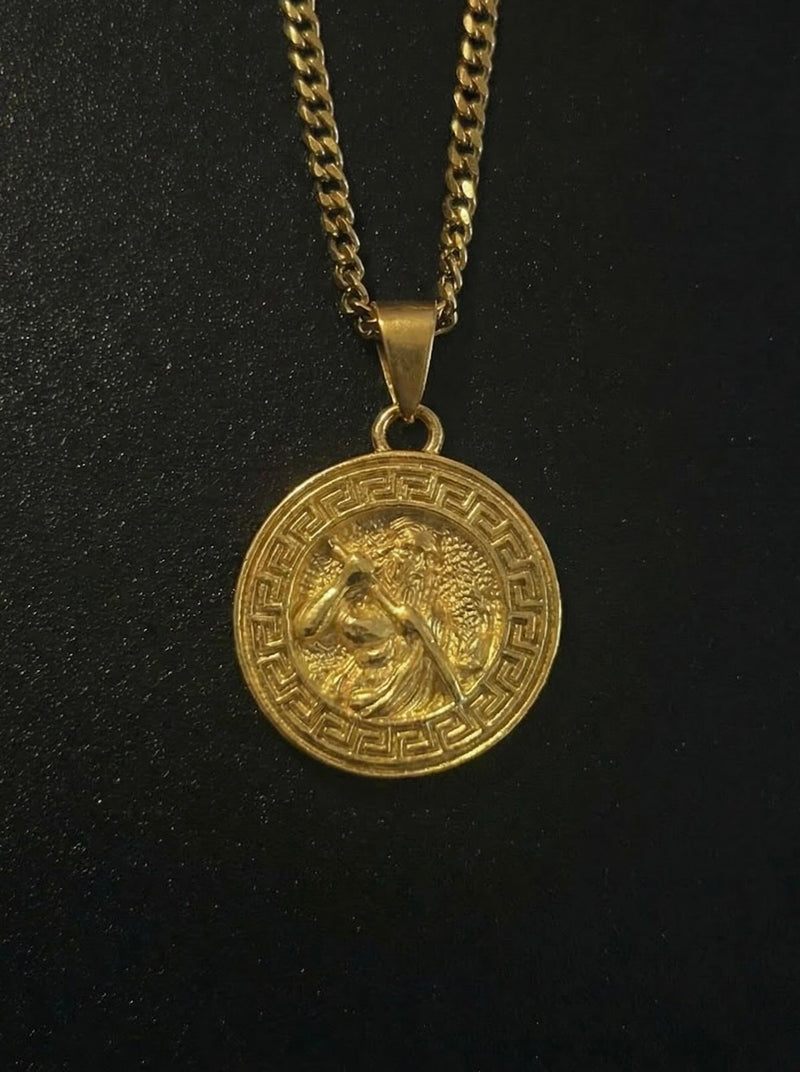 Gold Greek Zeus pendant with a bearded Zeus figure and Greek key border, close detail