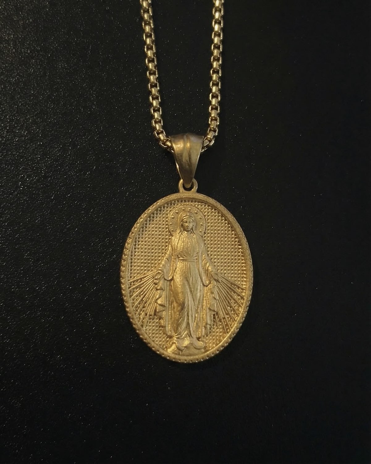 Gold Holy Mary Miraculous Medal pendant with Mary standing, arms open and rays of light, close detail