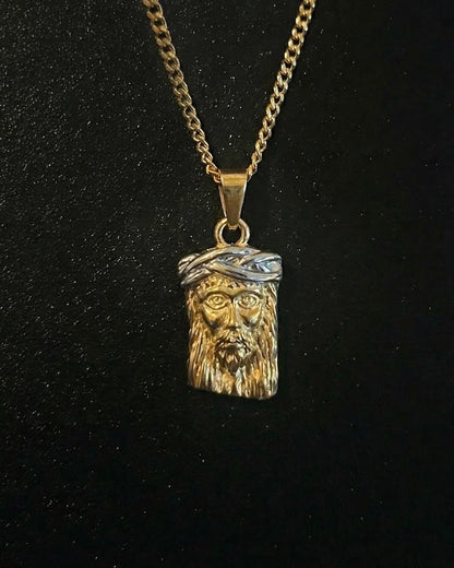 Gold Jesus head pendant with a 3D face of Christ and a silver-tone crown of thorns, close detail