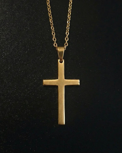 Gold minimalist cross pendant with a slim flat brushed finish, close detail