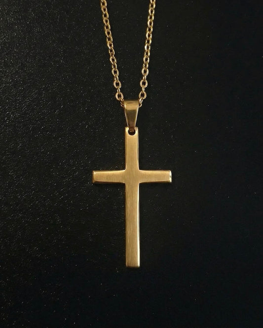 Gold minimalist cross pendant with a slim flat brushed finish, close detail