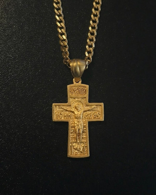 Gold Orthodox crucifix pendant with the crucifixion scene in detailed relief and inscriptions, close detail