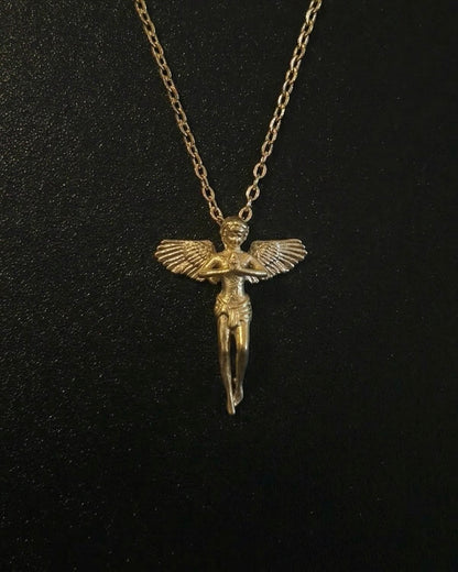 Gold praying angel pendant shaped into a standing winged angel with hands clasped in prayer, close detail
