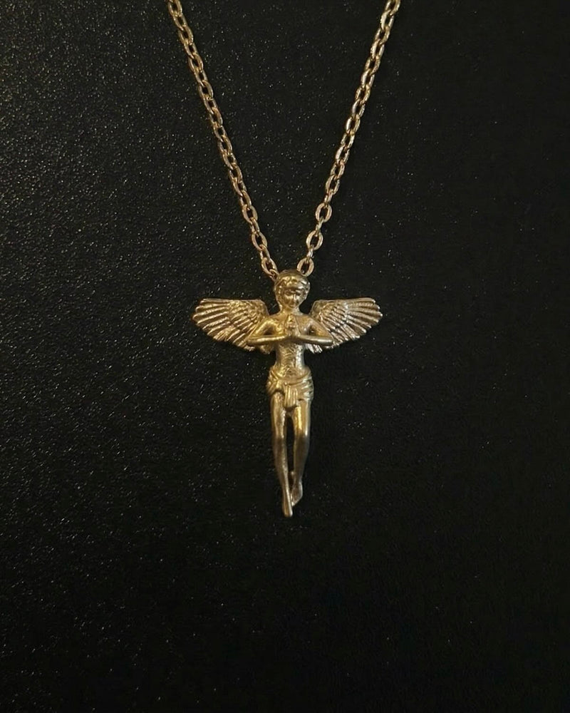 Gold praying angel pendant shaped into a standing winged angel with hands clasped in prayer, close detail