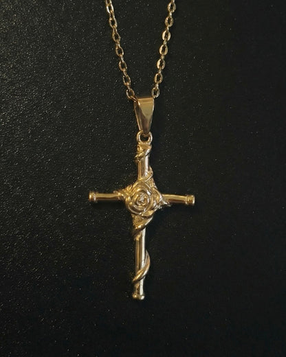 Gold rose cross pendant with a sculpted rose and vine down the lower arm, close detail
