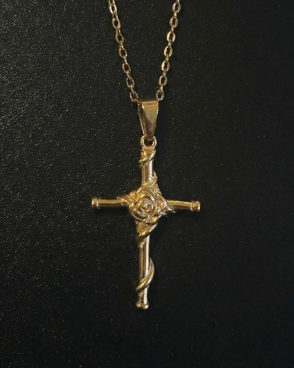 Gold rose cross pendant with a sculpted rose and vine down the lower arm, close detail