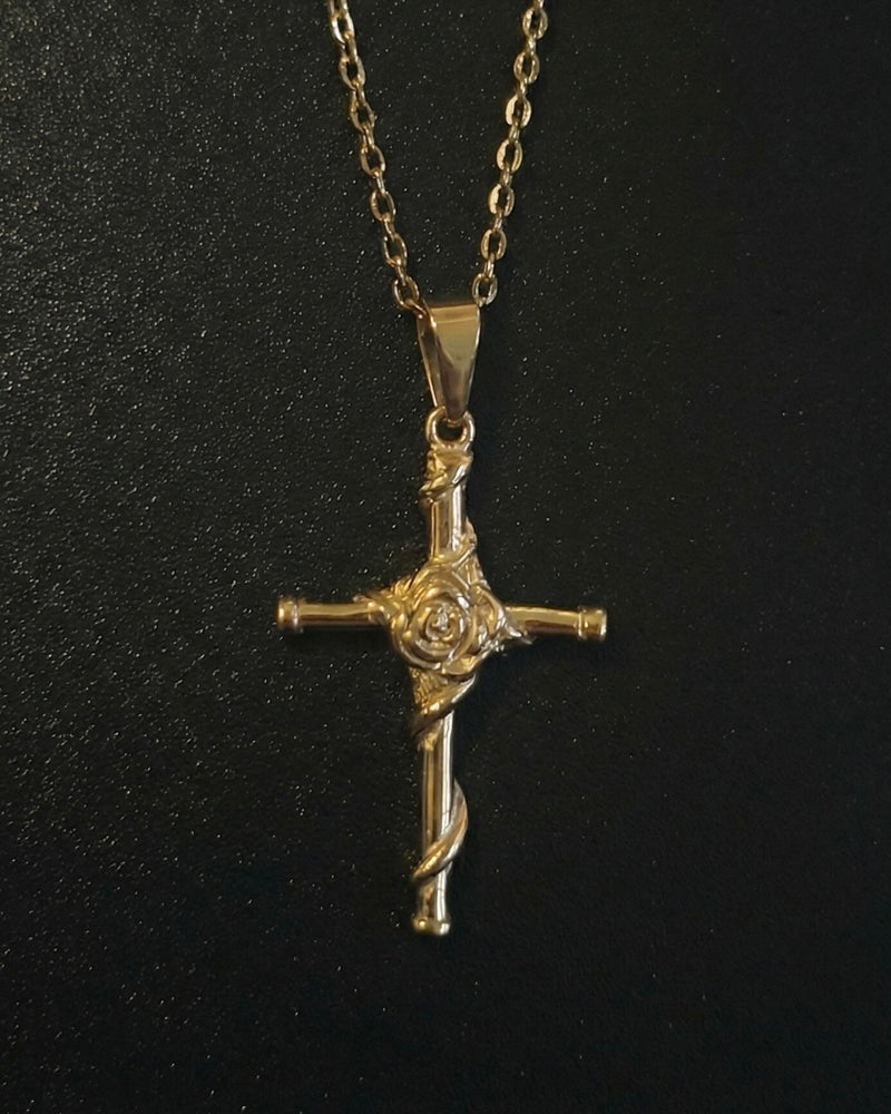 Gold rose cross pendant with a sculpted rose and vine down the lower arm, close detail