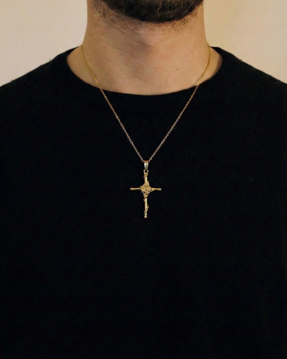 Man wearing a gold rose cross necklace on a 50cm chain over a black t-shirt