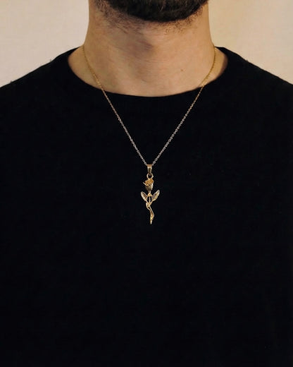 Man wearing a gold rose necklace on a 50cm chain over a black t-shirt