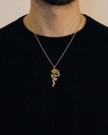 Man wearing a gold snake rose necklace on a 50cm chain over a black t-shirt