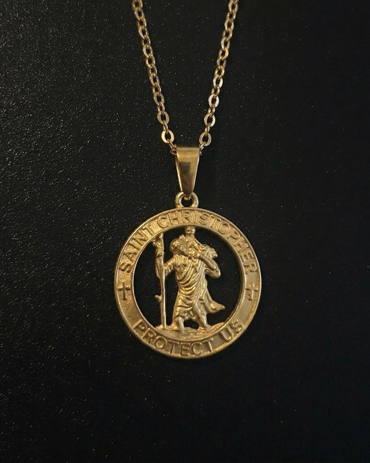 Gold St Christopher pendant with an open cut-out medallion and protect-us inscription, close detail