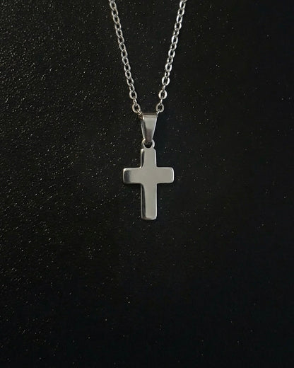 Silver cross pendant in a compact size with a polished mirror finish, close detail