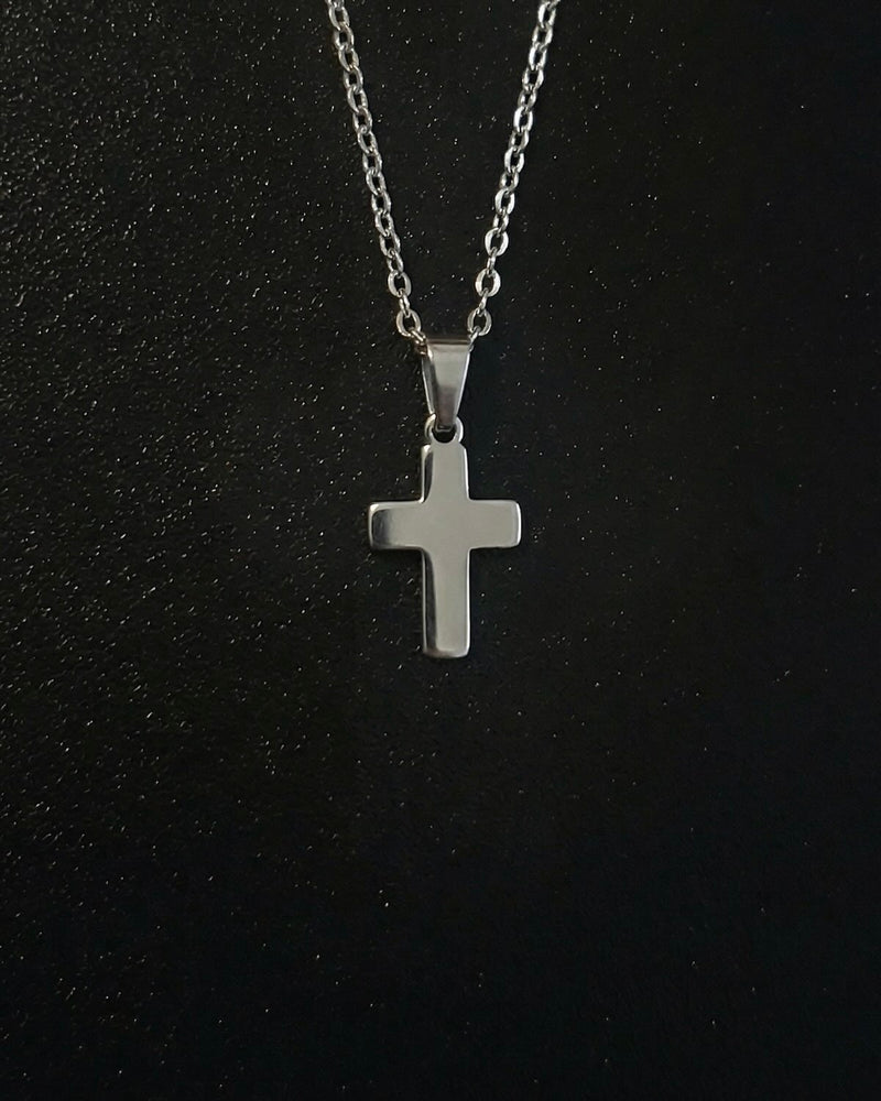 Silver cross pendant in a compact size with a polished mirror finish, close detail