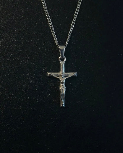 Silver crucifix pendant with the figure of Christ on a slim cross, close detail
