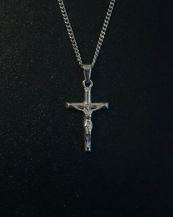 Silver crucifix pendant with the figure of Christ on a slim cross, close detail