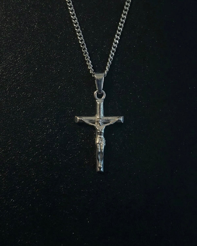 Silver crucifix pendant with the figure of Christ on a slim cross, close detail