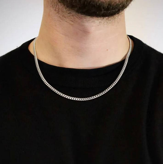4mm silver stainless steel Cuban link chain worn by a man over a black t-shirt