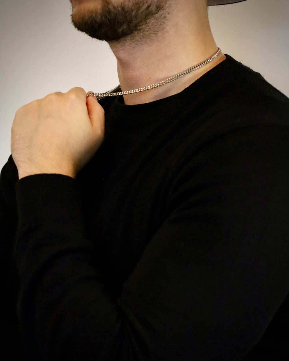 Man wearing a 4mm silver stainless steel curb Cuban link chain, close detail