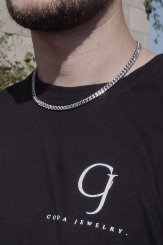 6mm silver stainless steel Miami Cuban link chain worn by a man in a black CODA Jewelry t-shirt
