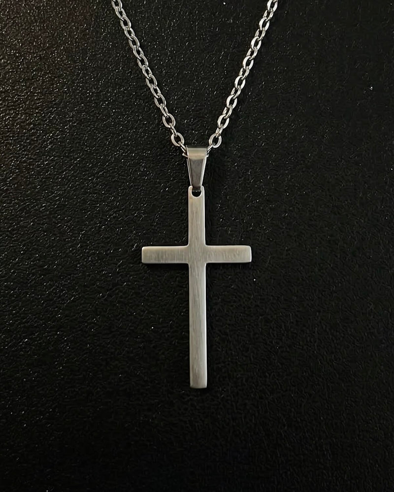 Silver minimalist cross pendant with a slim flat brushed finish, close detail