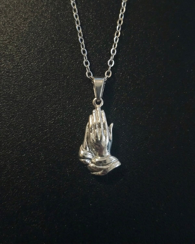 Silver praying hands pendant sculpted in 3D detail, close detail