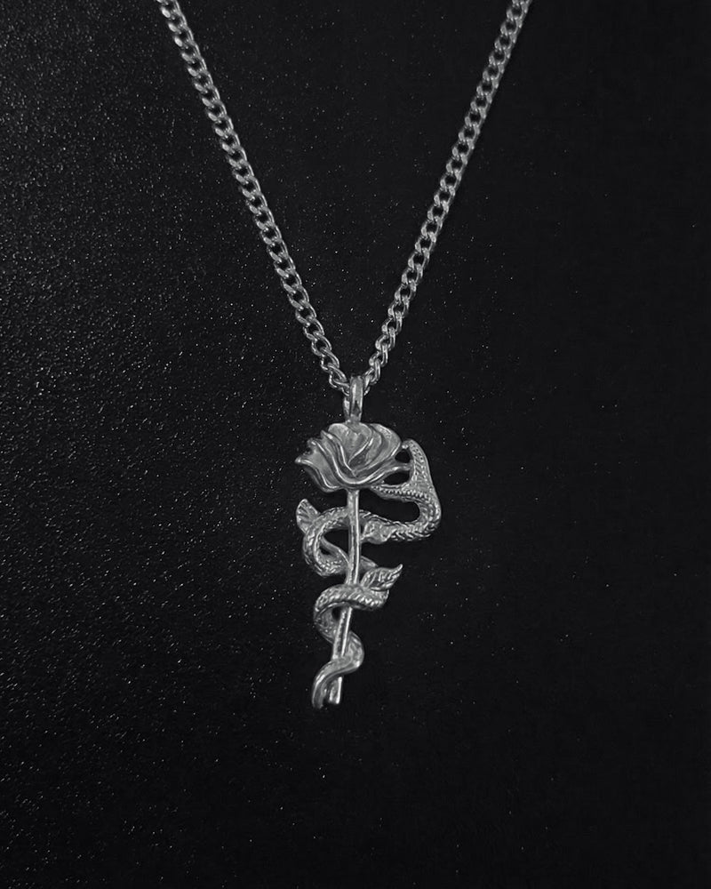 Silver snake rose pendant with a serpent coiled around a long-stemmed rose, close detail