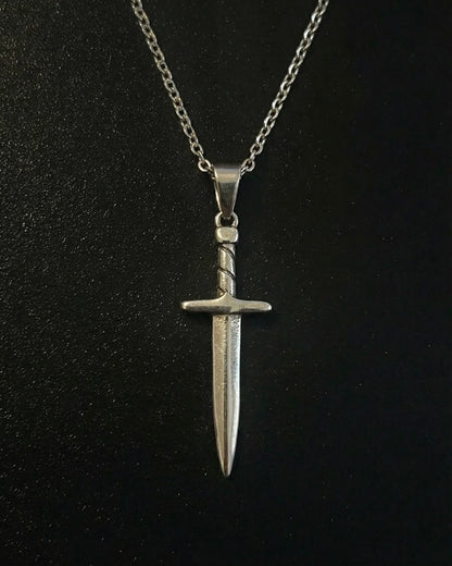 Silver sword pendant shaped like a dagger with a twisted wrapped handle, close detail