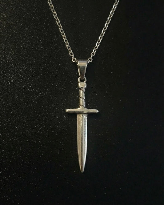 Silver sword pendant shaped like a dagger with a twisted wrapped handle, close detail