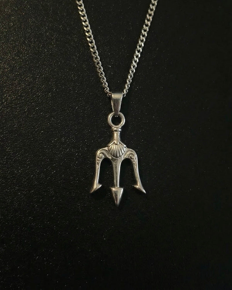 Silver trident pendant with three prongs and an ornate scrollwork crown, close detail